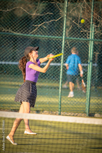 Attractive young girl playing tennis