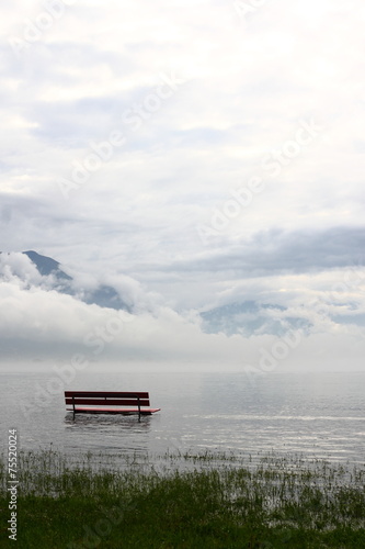 Bench on the lake shore during a flooding