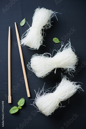 Raw chinese cellophane noodles, black wooden background