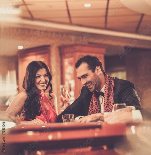 Couple behind poker table in a casino