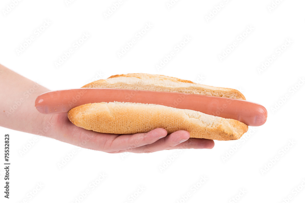 Hand holding hot dog bread and sausage. Hand holding hot dog bread and sausage.