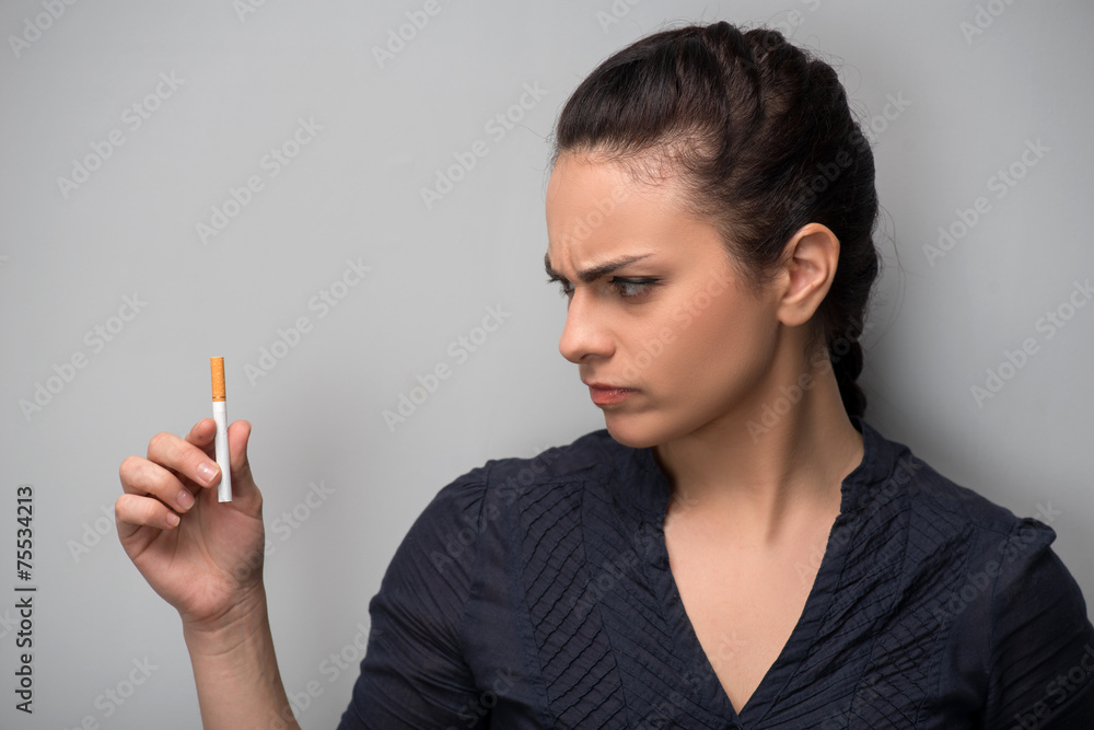 Obraz premium Addiction. Closeup of young woman determined girl holding cigare