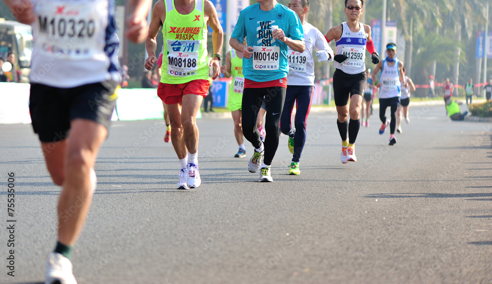 marathon athletes legs running on city road marathon athletes legs running on city road