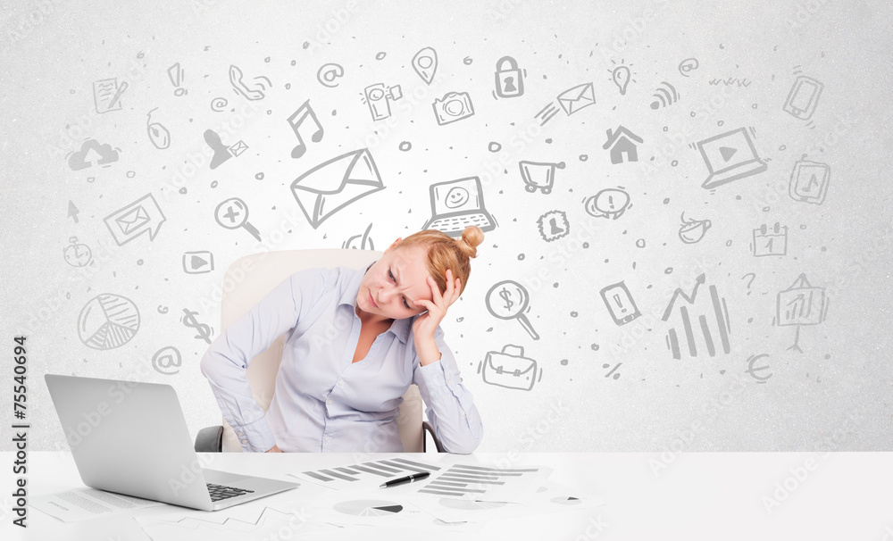 Business woman sitting at table with hand drawn media icons Business woman sitting at table with hand drawn media icons