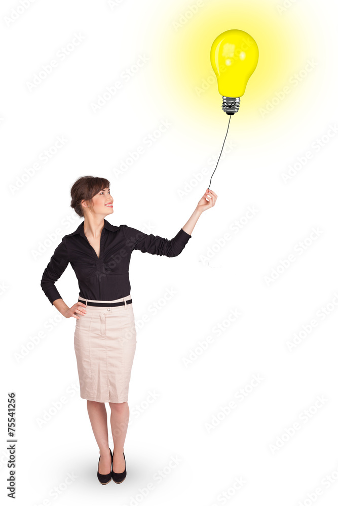 Happy woman holding a light bulb balloon Happy woman holding a light bulb balloon