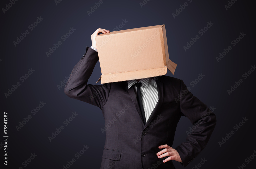 Fototapeta premium Businessman gesturing with a cardboard box on his head