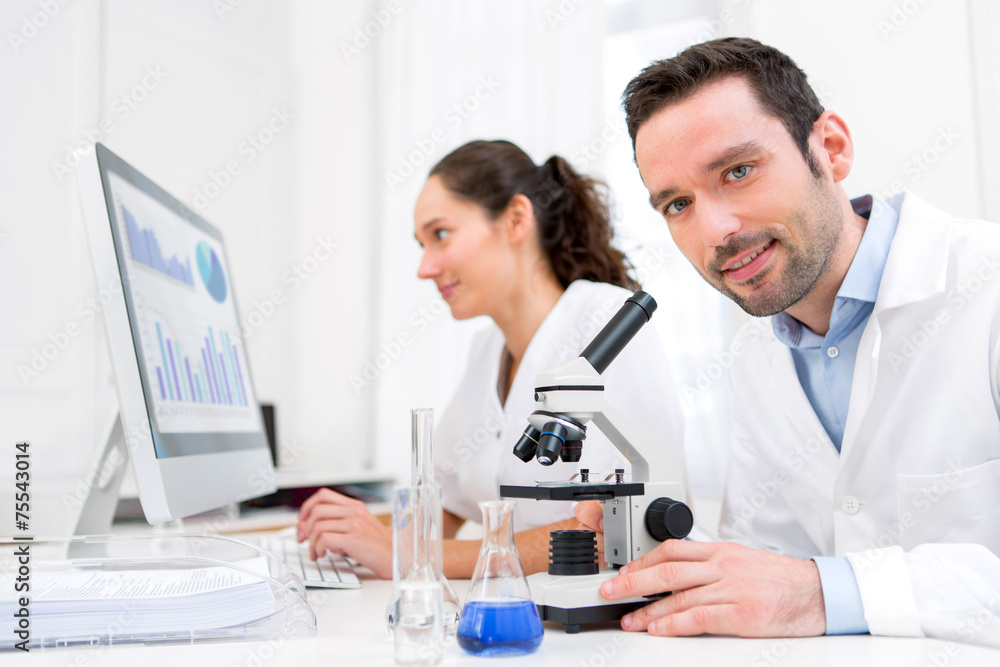 Scientist and her assistant in a laboratory Scientist and her assistant in a laboratory