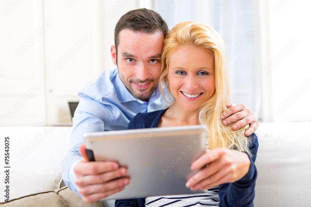 Young attractive couple having fun using tablet Young attractive couple having fun using tablet