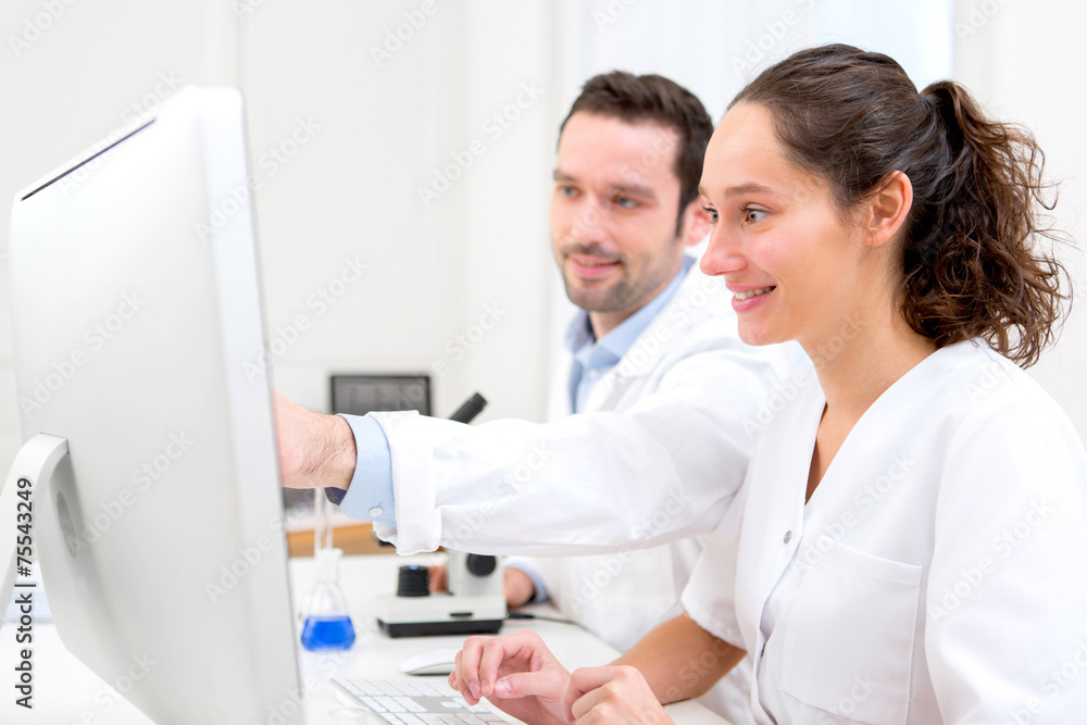 Scientist and her assistant in a laboratory Scientist and her assistant in a laboratory
