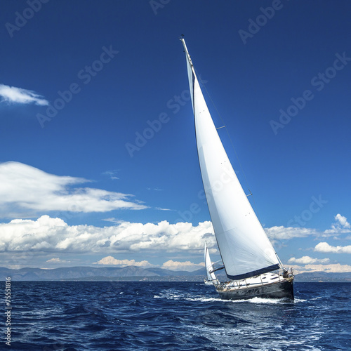 Yacht sails with beautiful cloudless sky. Luxury yacht.