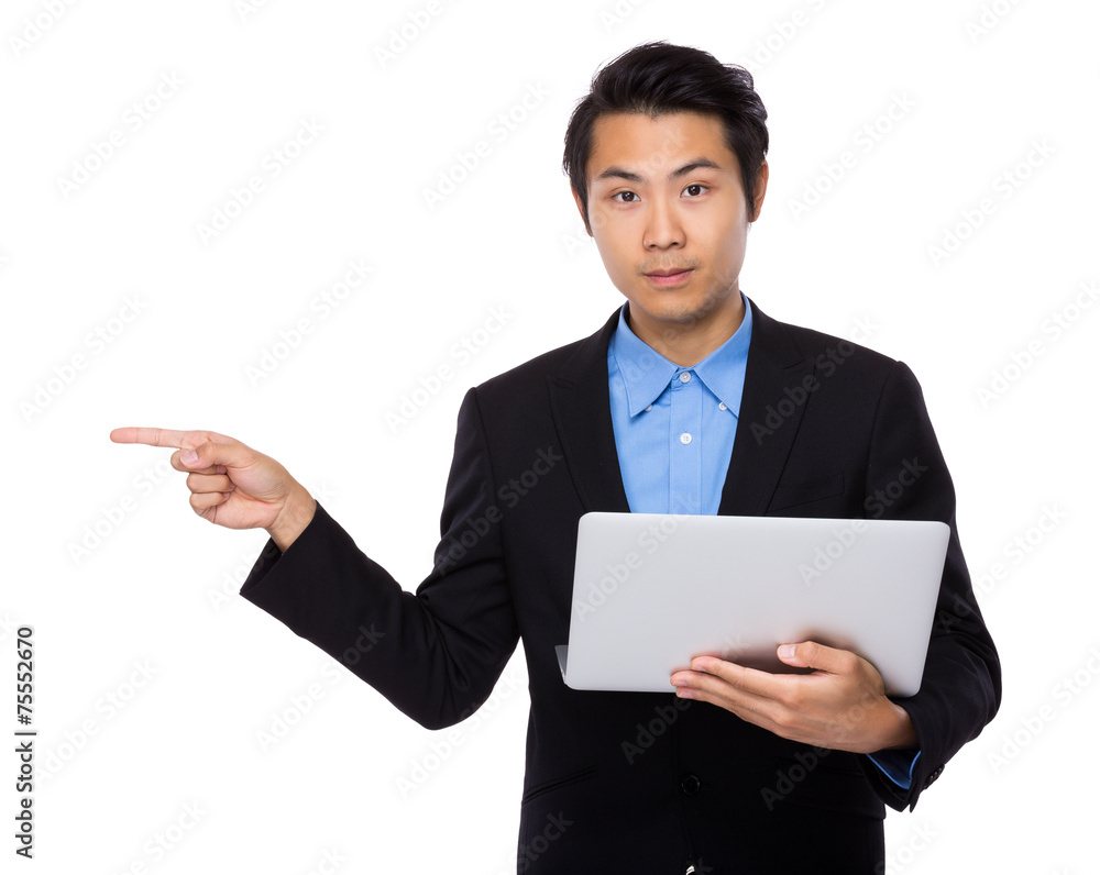 Businessman use of laptop and finger point aside Businessman use of laptop and finger point aside