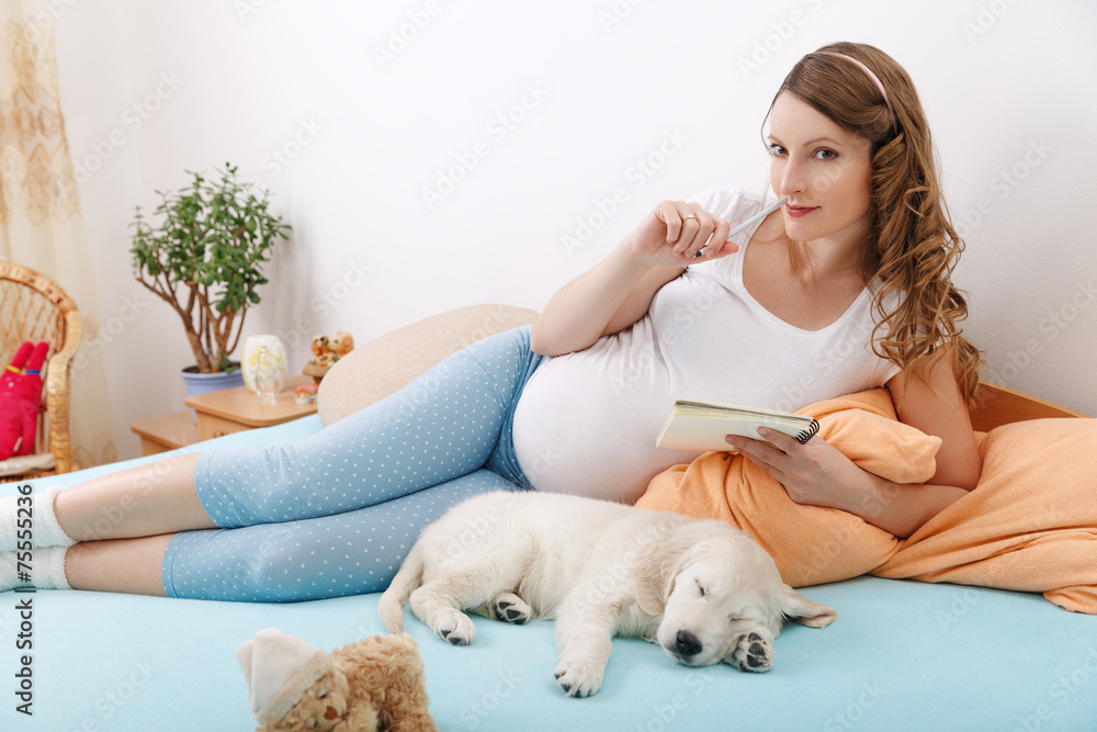 Pregnant woman with her dog at home Pregnant woman with her dog at home