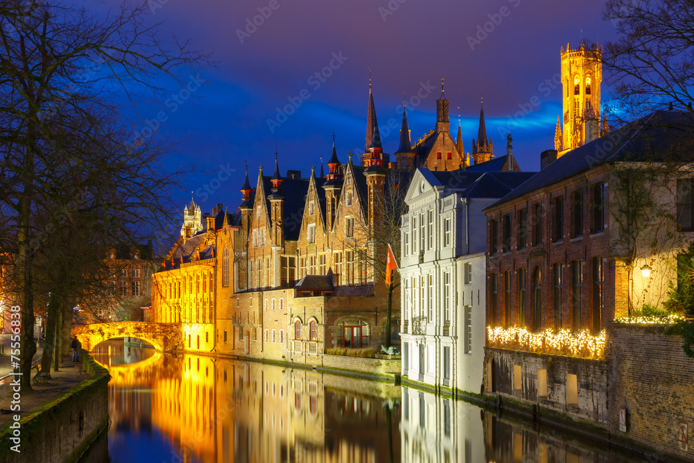 Cityscape with a tower Belfort and the Green canal in Bruges at