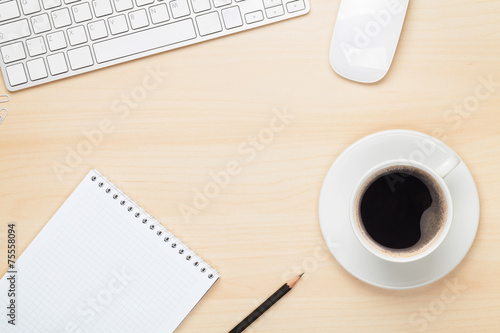 Office table with notepad  computer and coffee cup