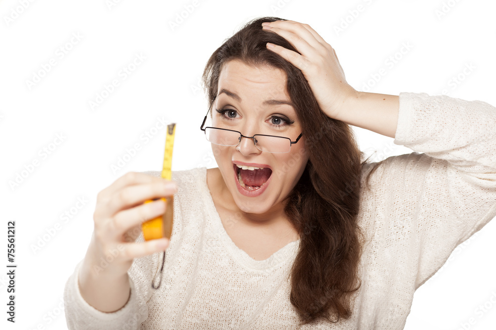 women laughed at the size shown on the measuring tape women laughed at the size shown on the measuring tape