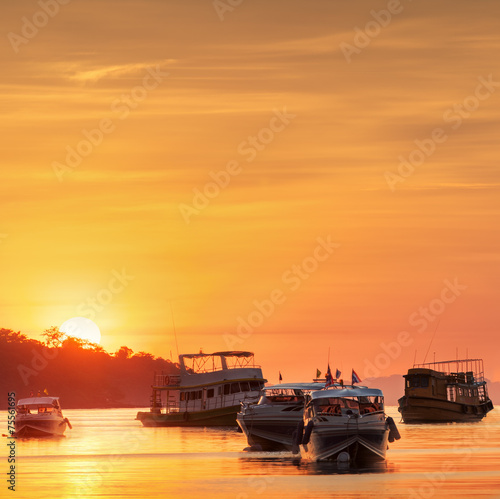 sunrise with colorful sky and boats