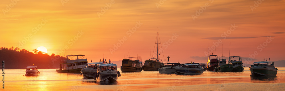 sunrise with colorful sky and boats