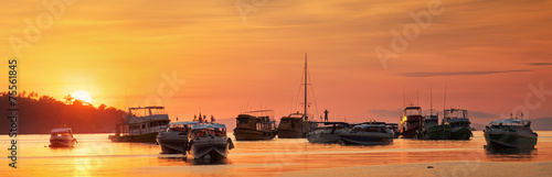 sunrise with colorful sky and boats