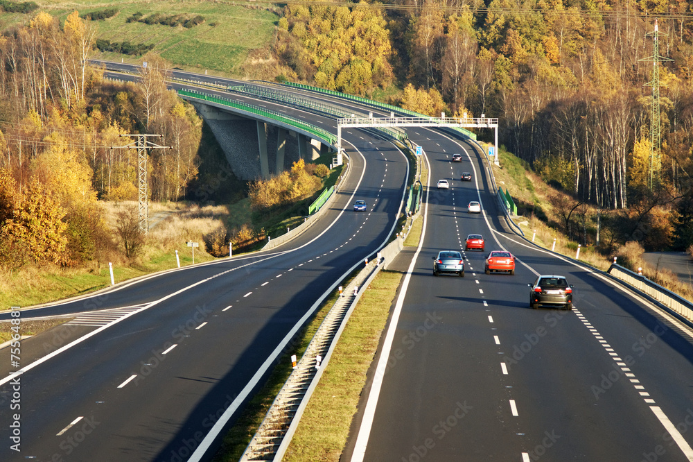 Cars on the highway leading across the bridge over the valley