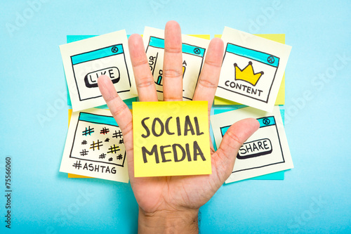 Sticky note with social media on hand with blue background. photo