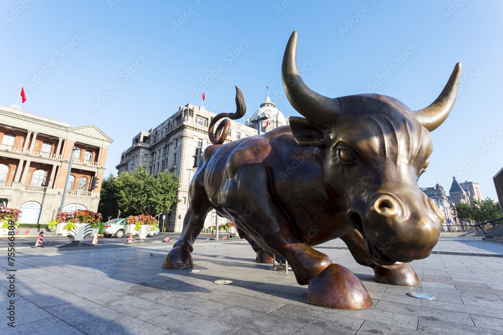 Fototapeta premium Copper Bull statue on the modern city street of shanghai.