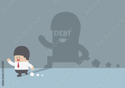 Businessman followed by debt shadow