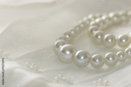 Pearl necklace on lace background,selected focus.