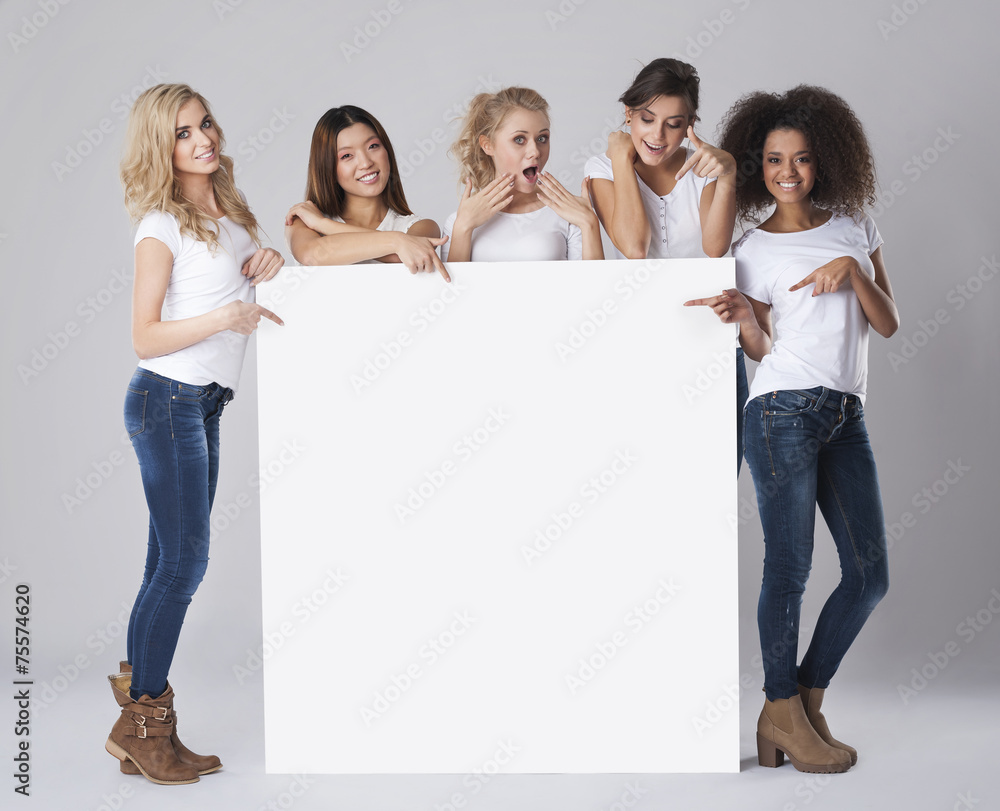 Multi ethnic group of women with empty whiteboard Multi ethnic group of women with empty whiteboard