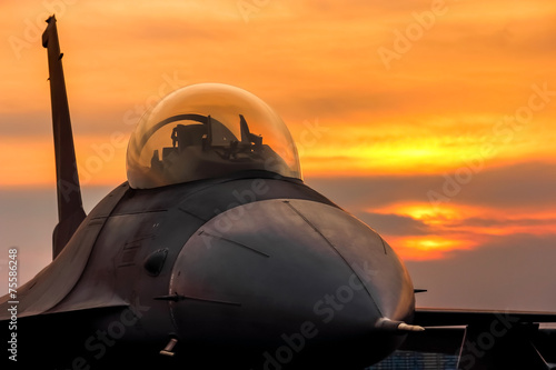 Canvas Print f16 falcon fighter jet on sunset  background