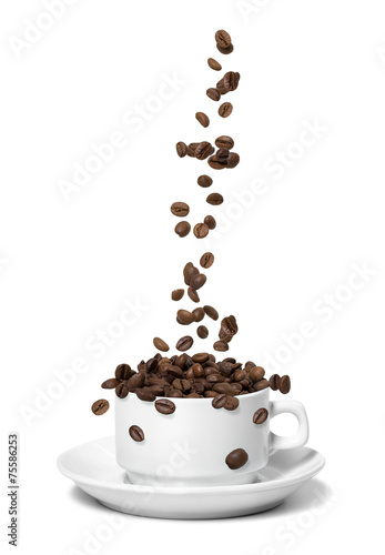 Coffee beans falling in white coffee cup. Highspeed shot