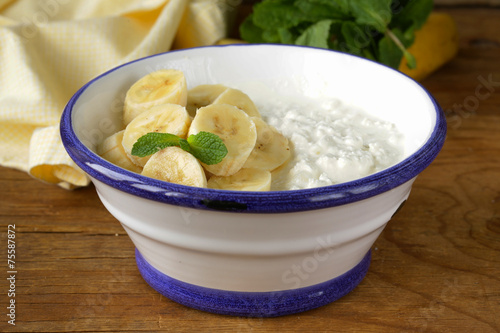 healthy breakfast cottage cheese with fresh banana photo