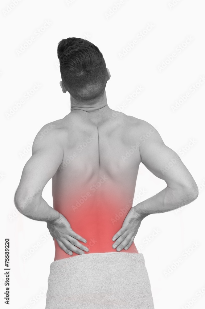 Fototapeta premium Rear view of shirtless man with back pain