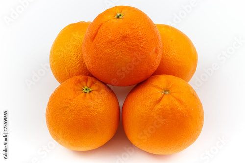 Oranges stacked as pyramid with white background