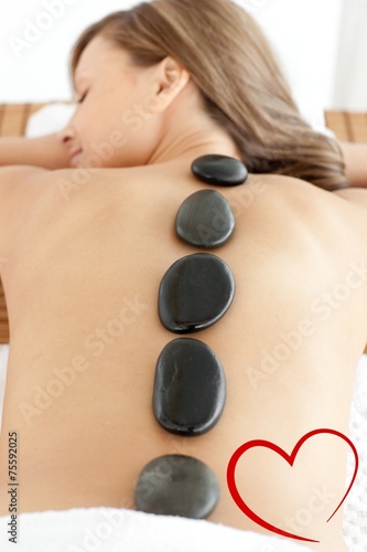 Composite image of sleeping woman lying on a massage table