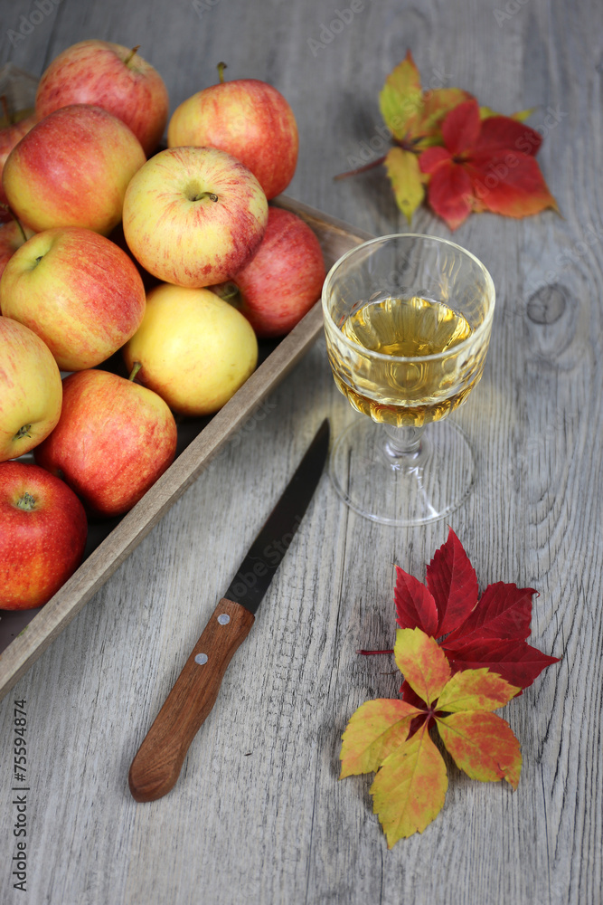 Apple juice, apples and autumn leaves