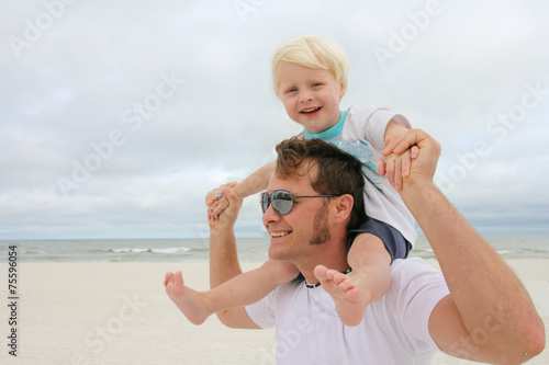 Father and Son Playing on Beach by Ocean