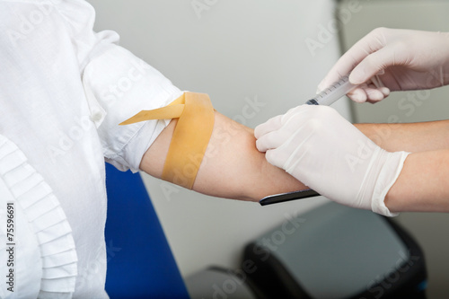 Nurse Taking Blood From Patient's Arm © Tyler Olson