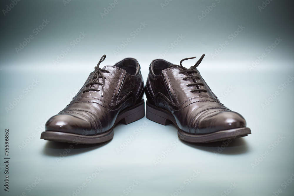 Classic leather shoes on abstract background
