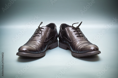 Classic leather shoes on abstract background