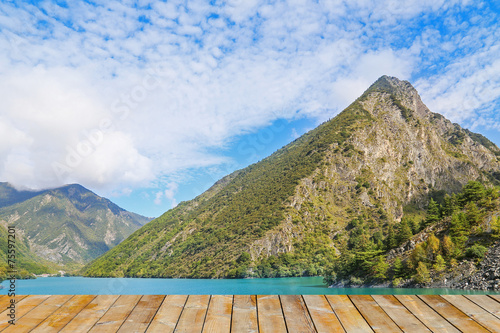 wooden platform before lake  with mountain
