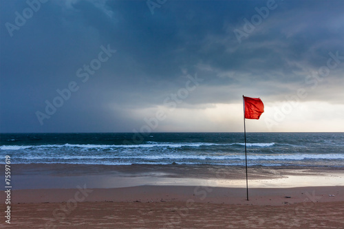 Storm warning flags on beach. Baga, Goa, India