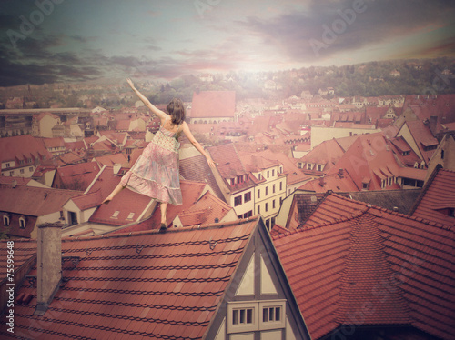 Young girl on top of the roof. Photomanipulation. Cncept digital