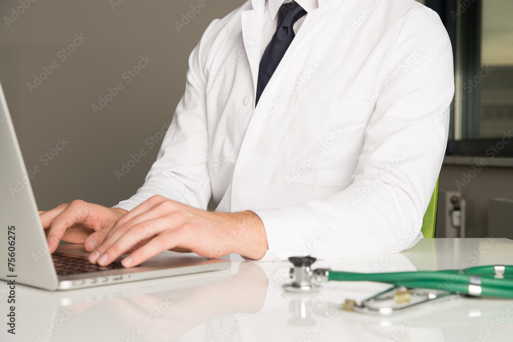 hands of doctor writing at computer hands of doctor writing at computer