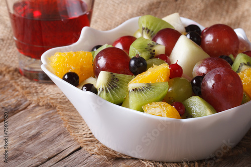 Fruit salad and grape juice close up. horizontal