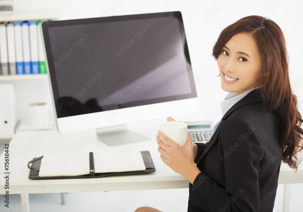 happy young businesswoman working in the office