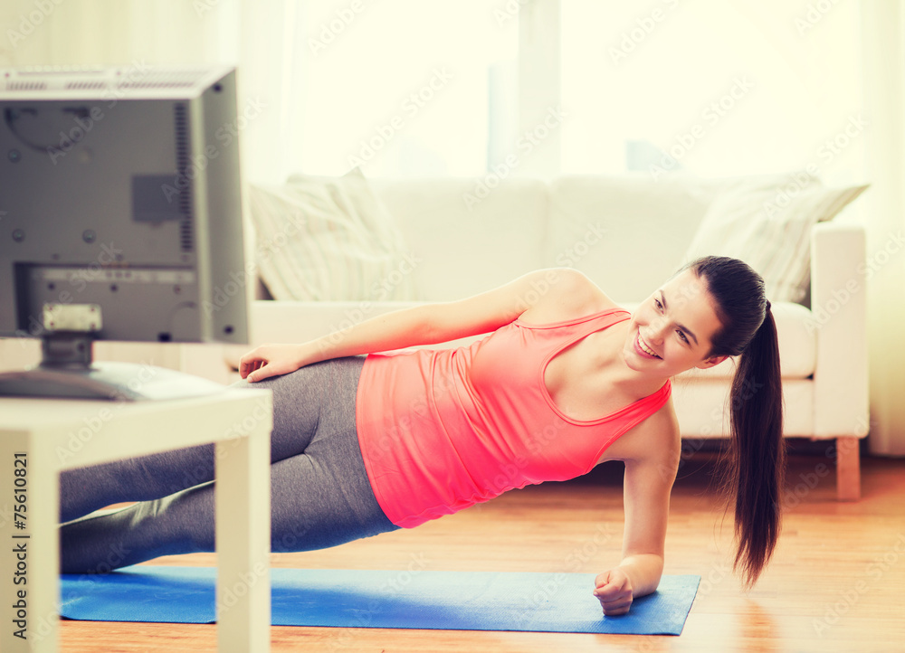 smiling teenage girl doing side plank at home smiling teenage girl doing side plank at home