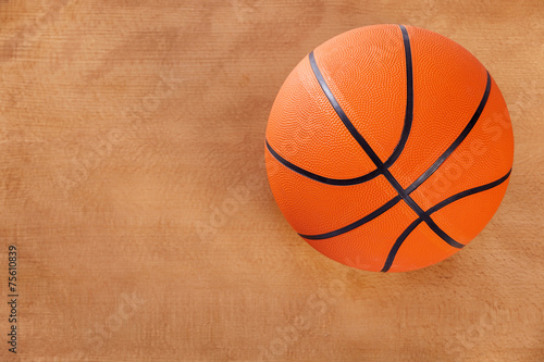 Basketball over wooden floor