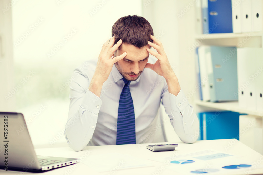 stressed businessman with laptop and documents stressed businessman with laptop and documents
