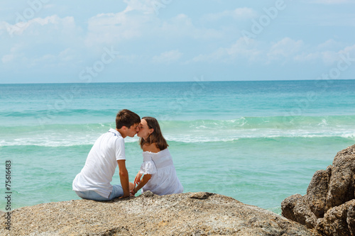 lovely young adult couple on the rocks