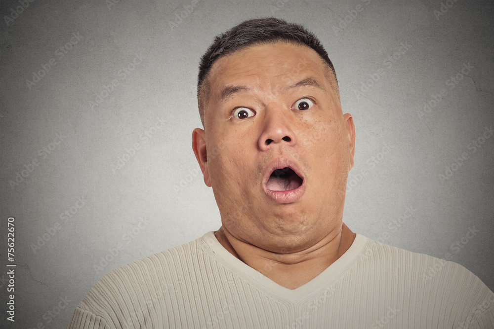 headshot shocked man isolated on grey wall background headshot shocked man isolated on grey wall background